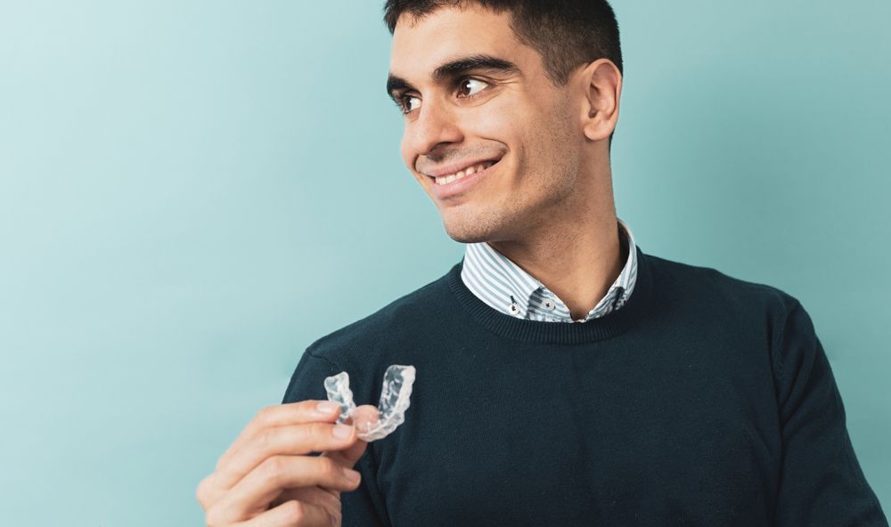 A man posing with resin splints for orthodontics