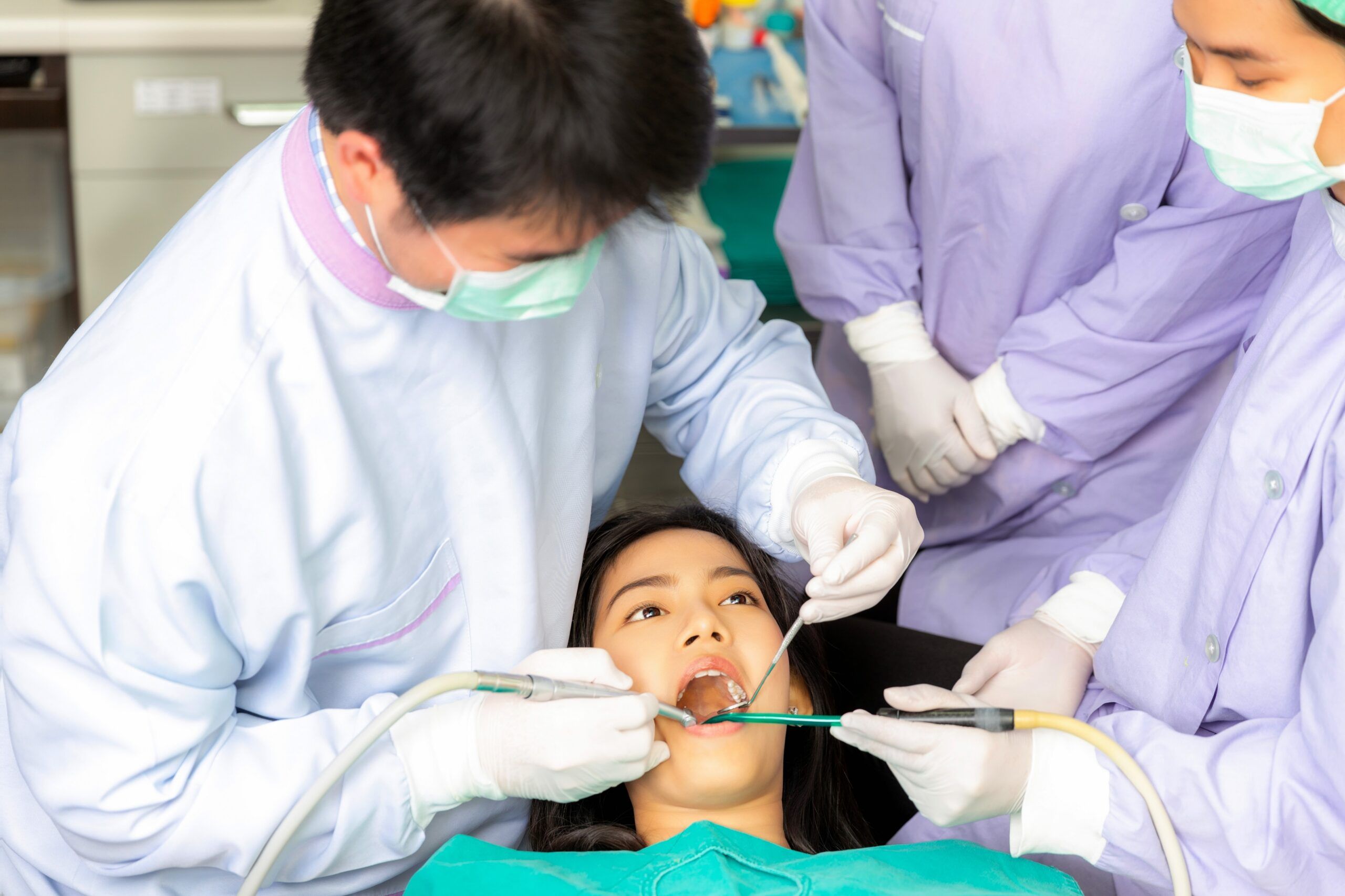 Asian woman decayed tooth operation in dental clinic with her dentist,